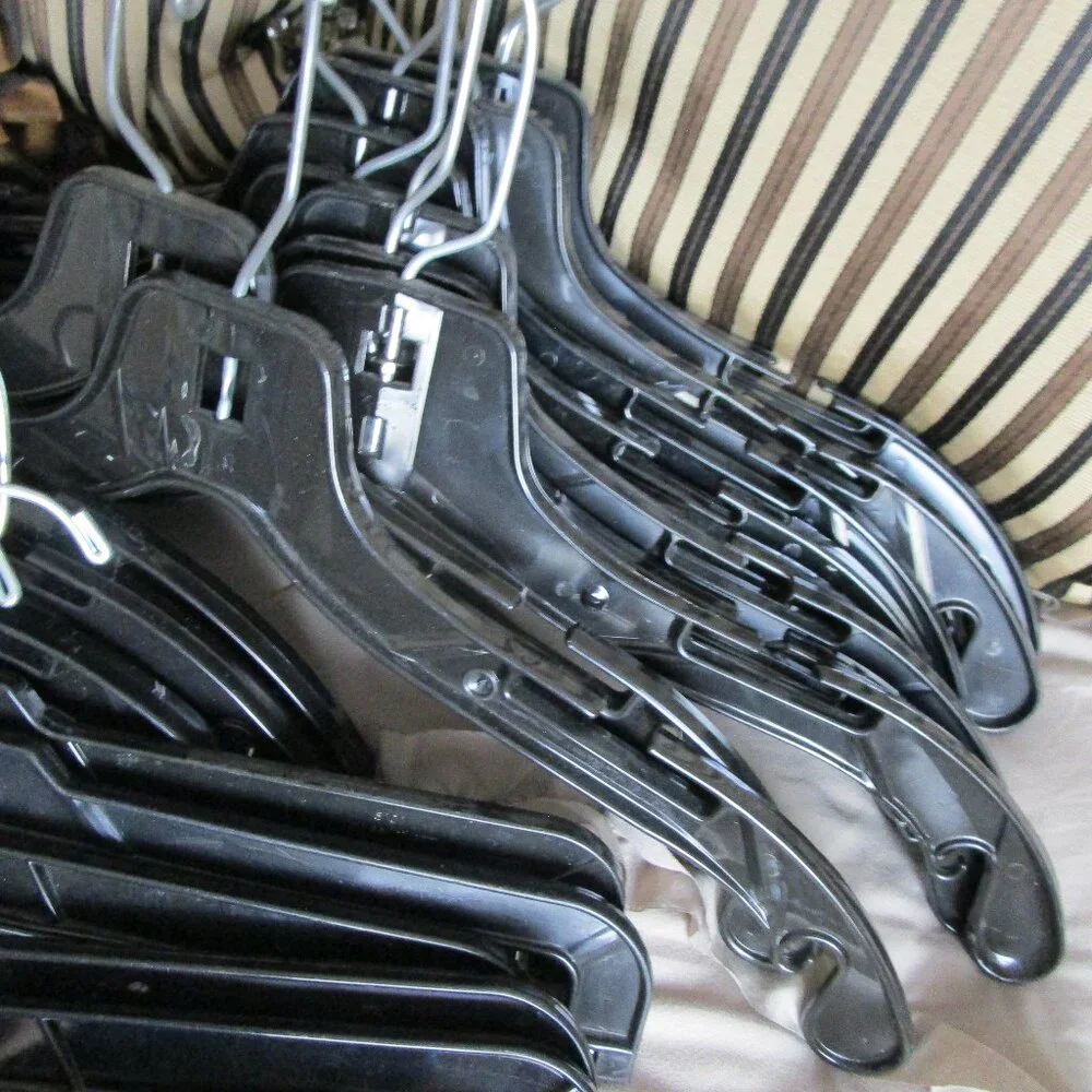 lot of black plastic hangers